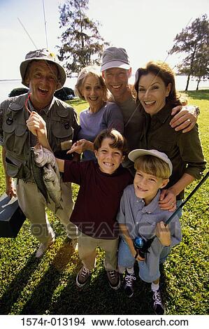 Portrait of a boy holding a fish with his parents and grandparents standing behind him View Large Photo Image Picture - Portrait of a boy holding a fish with his parents and grandparents standing behind him. Fotosearch