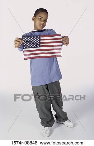 Stock Photograph - Portrait of a boy holding an American flag. Fotosearch