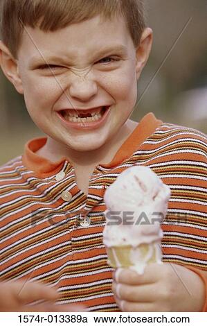 Portrait of a boy holding an ice cream cone View Large Photo Image Stock Image - Portrait of a boy holding an ice cream cone. Fotosearch