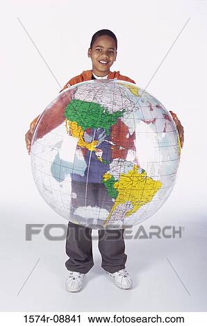 Portrait of a boy holding an inflatable globe View Large Photo Image Stock Image - Portrait of a boy holding an inflatable globe. Fotosearch