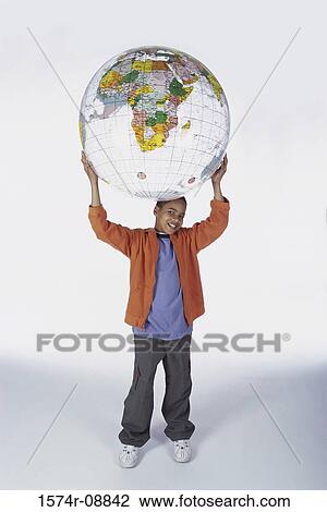 Portrait of a boy holding an inflatable globe on top of his head View Large Photo Image Stock Image - Portrait of a boy holding an inflatable globe on top of his head. Fotosearch