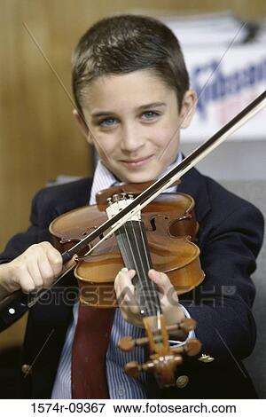Portrait of a boy playing a violin View Large Photo Image Stock Photo - Portrait of a boy playing a violin. Fotosearch