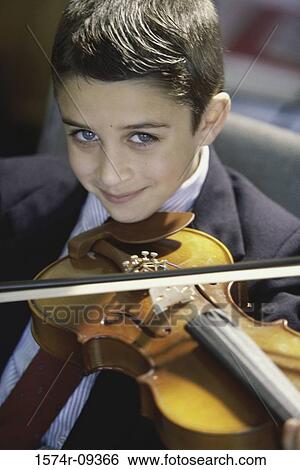 Portrait of a boy playing a violin View Large Photo Image Stock Photograph - Portrait of a boy playing a violin. Fotosearch