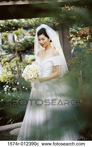 Portrait of a bride holding a bouquet View Large Photo Image Stock Image - Portrait of a bride holding a bouquet. Fotosearch
