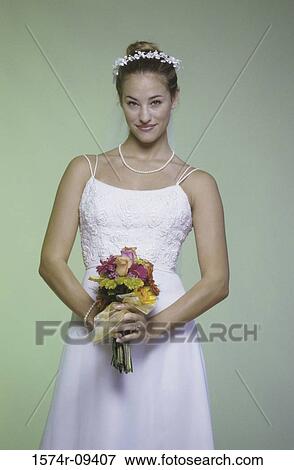 Portrait of a bride holding a bouquet of flowers View Large Photo Image Stock Photo - Portrait of a bride holding a bouquet of flowers. Fotosearch