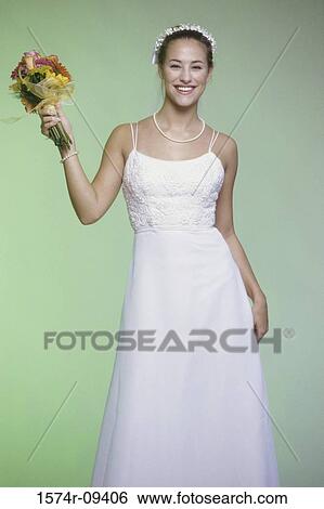 Portrait of a bride holding a bouquet of flowers View Large Photo Image Stock Photograph - Portrait of a bride holding a bouquet of flowers. Fotosearch
