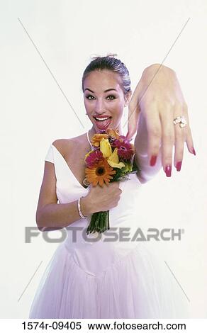 Stock Photography - Portrait of a bride showing her wedding ring. Fotosearch