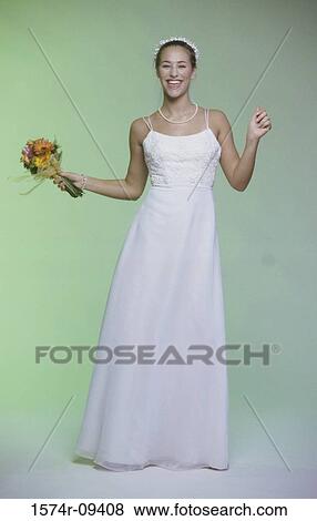 Portrait of a bride smiling holding a bouquet of flowers View Large Photo Image Stock Photo - Portrait of a bride smiling holding a bouquet of flowers. Fotosearch