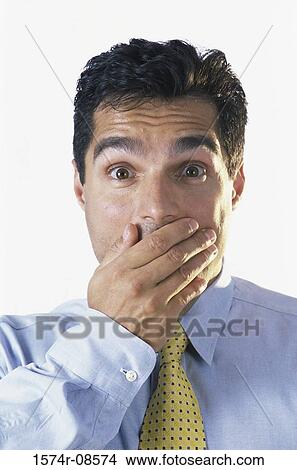 Picture - Portrait of a businessman with his hand covering his mouth. Fotosearch