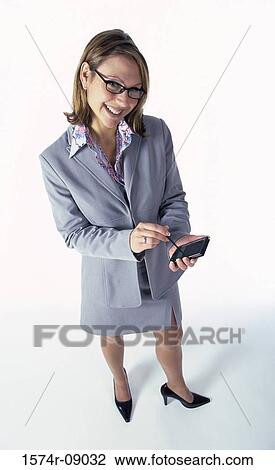 Portrait of a businesswoman holding a hand held device View Large Photo Image Stock Image - Portrait of a businesswoman holding a hand held device. Fotosearch