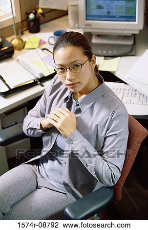 Stock Image - Portrait of a businesswoman in an office. Fotosearch