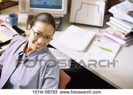 Stock Image - Portrait of a businesswoman in an office. Fotosearch