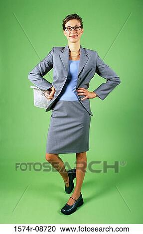 Stock Image - Portrait of a businesswoman standing with her hands on her hips. Fotosearch
