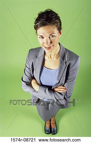 Stock Image - Portrait of a businesswoman standing with her arms folded. Fotosearch