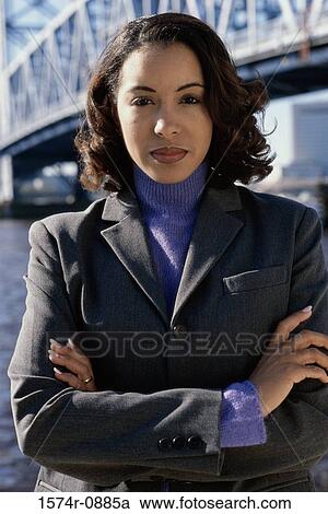 Portrait of a businesswoman standing with her arms folded View Large Photo Image Stock Image - Portrait of a businesswoman standing with her arms folded. Fotosearch