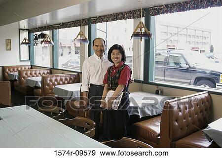 Portrait of a couple standing in a restaurant View Large Photo Image Stock Photo - Portrait of a couple standing in a restaurant. Fotosearch