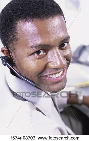 Portrait of a customer service representative wearing a headset smiling View Large Photo Image Stock Image - Portrait of a customer service representative wearing a headset smiling. Fotosearch
