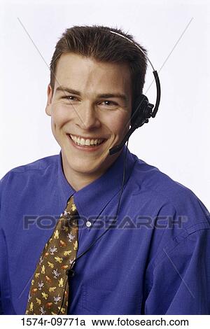 Stock Image - Portrait of a customer service representative wearing a headset smiling. Fotosearch
