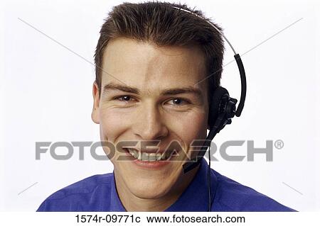 Stock Image - Portrait of a customer service representative wearing a headset smiling. Fotosearch