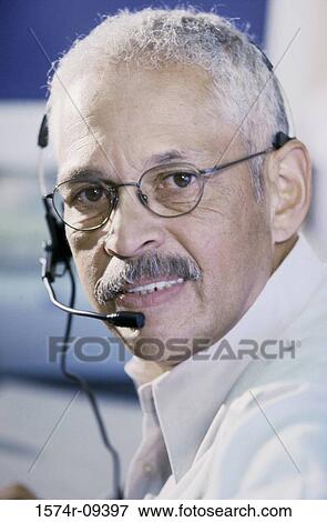 Portrait of a customer service representative wearing a headset View Large Photo Image Stock Photo - Portrait of a customer service representative wearing a headset. Fotosearch