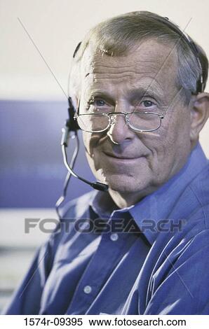 Stock Photography - Portrait of a customer service representative wearing a headset. Fotosearch