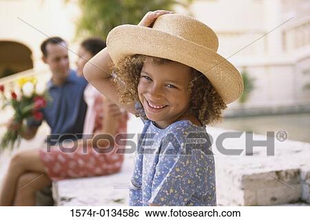 Portrait of a daughter smiling with her parents sitting behind her View Large Photo Image Stock Image - Portrait of a daughter smiling with her parents sitting behind her. Fotosearch