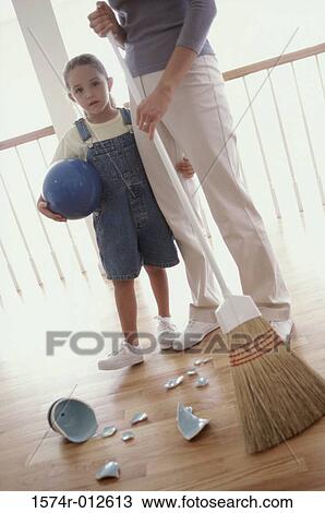 Portrait of a daughter standing with her mother near broken pieces of crockery View Large Photo Image Stock Image - Portrait of a daughter standing with her mother near broken pieces of crockery. Fotosearch