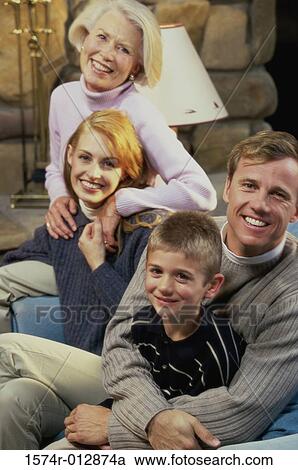 Stock Image - Portrait of a family sitting in a living room. Fotosearch