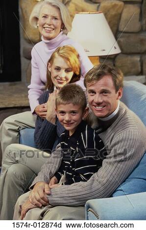 Portrait of a family sitting in a living room View Large Photo Image Stock Image - Portrait of a family sitting in a living room. Fotosearch
