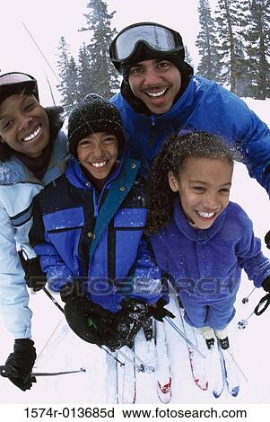 Portrait of a family standing together in the snow View Large Photo Image Stock Image - Portrait of a family standing together in the snow. Fotosearch
