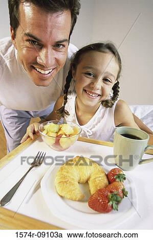 Portrait of a father and his daughter holding a breakfast tray View Large Photo Image Stock Image - Portrait of a father and his daughter holding a breakfast tray. Fotosearch