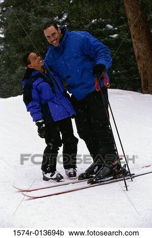 Portrait of a father and son standing in snow View Large Photo Image Stock Image - Portrait of a father and son standing in snow. Fotosearch