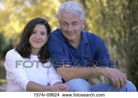 Picture - Portrait of a father sitting with his daughter. Fotosearch