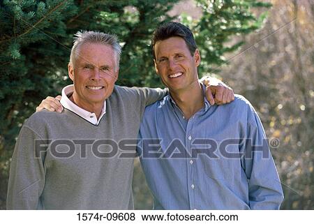 Portrait of a father standing with his son View Large Photo Image Stock Photo - Portrait of a father standing with his son. Fotosearch