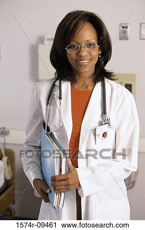 Portrait of a female doctor holding a medical record View Large Photo Image Stock Image - Portrait of a female doctor holding a medical record. Fotosearch