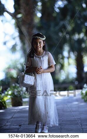 Picture - Portrait of a flower girl holding a basket. Fotosearch