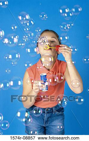Portrait of a girl blowing soap bubbles View Large Photo Image Stock Photo - Portrait of a girl blowing soap bubbles. Fotosearch