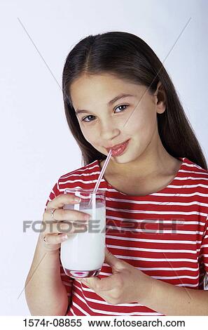 Stock Photography - Portrait of a girl drinking milk with a straw. Fotosearch