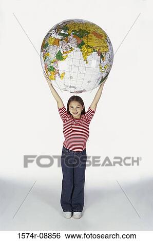 Portrait of a girl holding an inflatable globe View Large Photo Image Stock Photograph - Portrait of a girl holding an inflatable globe. Fotosearch