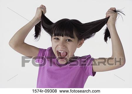 Portrait of a girl pulling her hair View Large Photo Image Stock Photo - Portrait of a girl pulling her hair. Fotosearch