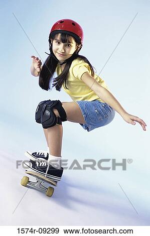 Portrait of a girl riding a skateboard View Large Photo Image Stock Photo - Portrait of a girl riding a skateboard. Fotosearch