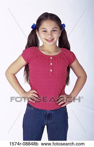 Portrait of a girl standing with arms akimbo View Large Photo Image Stock Image - Portrait of a girl standing with arms akimbo. Fotosearch