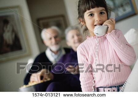 Stock Image - Portrait of a girl talking on the telephone. Fotosearch