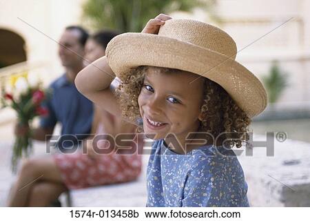 Stock Image - Portrait of a girl wearing a hat. Fotosearch