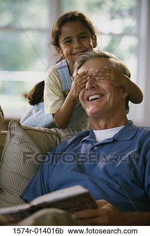 Portrait of a granddaughter covering her grandfather's eyes View Large Photo Image Stock Image - Portrait of a granddaughter covering her grandfather's eyes. Fotosearch