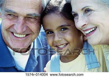 Portrait of a granddaughter smiling with her grandparents View Large Photo Image Picture - Portrait of a granddaughter smiling with her grandparents. Fotosearch