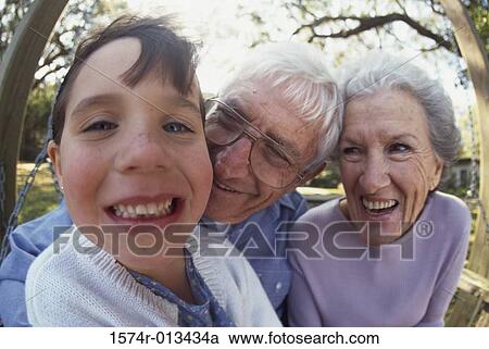 Portrait of a granddaughter smiling with her grandparents View Large Photo Image Stock Image - Portrait of a granddaughter smiling with her grandparents. Fotosearch