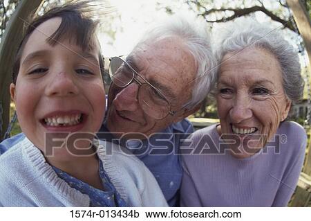 Portrait of a granddaughter smiling with her grandparents View Large Photo Image Stock Image - Portrait of a granddaughter smiling with her grandparents. Fotosearch