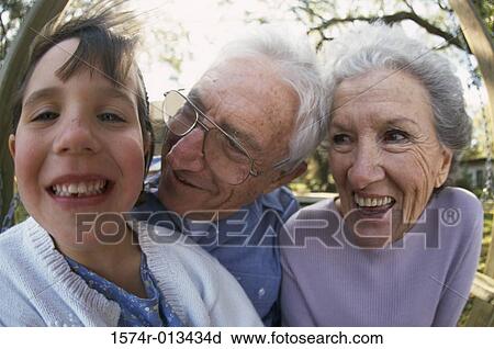 Portrait of a granddaughter smiling with her grandparents View Large Photo Image Stock Image - Portrait of a granddaughter smiling with her grandparents. Fotosearch