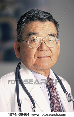 Picture - Portrait of a male doctor smiling with a stethoscope around his neck. Fotosearch
